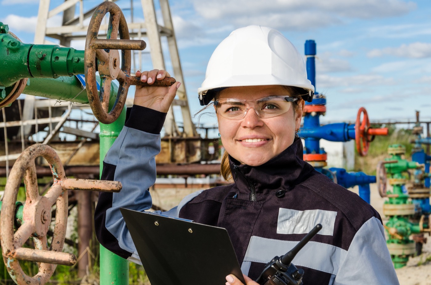 Engineer logging a wellhead in the field