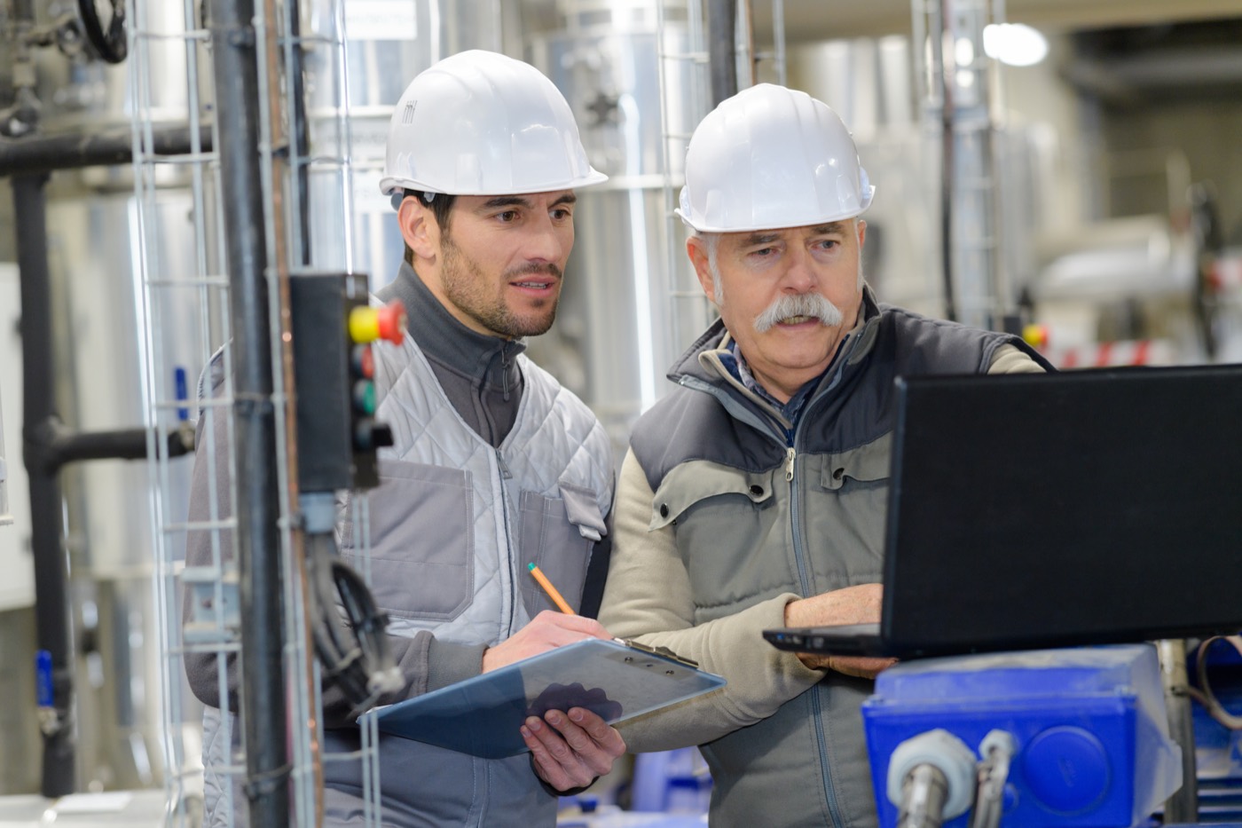 A service crew working a plant with a laptop